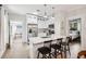 Bright kitchen featuring an island with seating, stainless appliances and views into the living room and bedroom at 112 E Spruce St, Orlando, FL 32804