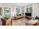 Bright living room with hardwood floors, abundant natural light, and stylish furnishings at 112 E Spruce St, Orlando, FL 32804