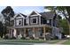 Charming two-story home with a welcoming porch and beautiful landscaping at 1207 Ridge Lake Way, Oakland, FL 34787
