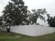 Backyard with a white fence and many trees at 1600 Roosevelt Ave, Orlando, FL 32804