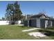Backyard with grey house, trees and a white fence at 1600 Roosevelt Ave, Orlando, FL 32804