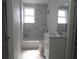 Modern bathroom showcasing a new vanity, tub, and tiled shower, perfect for relaxation at 1600 Roosevelt Ave, Orlando, FL 32804