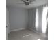 Inviting bedroom featuring neutral paint, tile flooring, and natural light from a window at 1600 Roosevelt Ave, Orlando, FL 32804