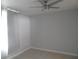 Spacious bedroom with ceiling fan, tile flooring, and plenty of natural light at 1600 Roosevelt Ave, Orlando, FL 32804