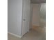 Hallway with neutral walls, tiled flooring and two white doors at 1600 Roosevelt Ave, Orlando, FL 32804