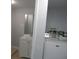 Small laundry area with washing machine, next to the bath at 1600 Roosevelt Ave, Orlando, FL 32804