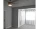 Bright living room with new gray vinyl flooring, white trim, and sheer curtains at 1600 Roosevelt Ave, Orlando, FL 32804