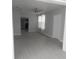 Bright living room with new gray vinyl flooring and a ceiling fan at 1600 Roosevelt Ave, Orlando, FL 32804
