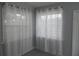 Bright living room with new gray vinyl flooring, white trim, and sheer curtains at 1600 Roosevelt Ave, Orlando, FL 32804
