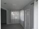 Bright living room with new gray vinyl flooring, white trim, and sheer curtains at 1600 Roosevelt Ave, Orlando, FL 32804