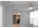 Cozy living room featuring a ceiling fan and a view into the well appointed kitchen at 1600 Roosevelt Ave, Orlando, FL 32804