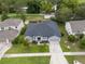 Aerial view of house showcasing new roof and landscaping at 1780 Nature Cove Ln, Clermont, FL 34711