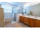 Bathroom features a soaking tub, walk-in shower and dual sink vanity at 1780 Nature Cove Ln, Clermont, FL 34711