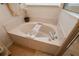 Bathroom features a soaking tub with bath caddy at 1780 Nature Cove Ln, Clermont, FL 34711