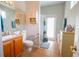 Bright bathroom featuring a vanity, toilet, shower, and neutral tile floors at 1780 Nature Cove Ln, Clermont, FL 34711