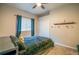 Bedroom with a ceiling fan, closet, and a window with decorative curtains at 1780 Nature Cove Ln, Clermont, FL 34711