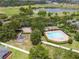 A community pool and playground are surrounded by lush greenery, offering residents a relaxing and recreational space at 1780 Nature Cove Ln, Clermont, FL 34711