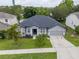 Well-maintained home with a two-car garage, lush lawn and tidy landscaping at 1780 Nature Cove Ln, Clermont, FL 34711