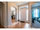Warm and inviting foyer with tile flooring, chandelier, and a welcome sign above the doorway at 1780 Nature Cove Ln, Clermont, FL 34711
