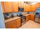 Well-appointed kitchen with wood cabinets, stainless steel appliances, and ample counter space at 1780 Nature Cove Ln, Clermont, FL 34711