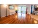 Bright and airy living room featuring hardwood floors, neutral walls and a piano at 1780 Nature Cove Ln, Clermont, FL 34711