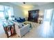 Cozy living room features stylish furniture, rug and sliding glass doors to lanai at 1780 Nature Cove Ln, Clermont, FL 34711