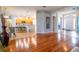 Spacious living area showcasing beautiful hardwood floors, an open floor plan and a view of the kitchen at 1780 Nature Cove Ln, Clermont, FL 34711