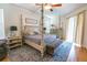 Bedroom with a four poster bed, area rug, and access to the lanai at 1780 Nature Cove Ln, Clermont, FL 34711
