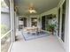 Covered patio with tile flooring, ceiling fan and patio table at 1780 Nature Cove Ln, Clermont, FL 34711
