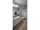 Stylish bathroom features modern fixtures, patterned wallpaper, and a spacious vanity at 1930 Dolphin Drive, Kissimmee, FL 34759