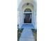Elegant front door with decorative stone accents and an arched transom window at 1930 Dolphin Drive, Kissimmee, FL 34759