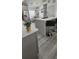 Kitchen with stainless steel appliances and gray cabinets and a breakfast bar at 1930 Dolphin Drive, Kissimmee, FL 34759
