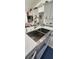 Modern kitchen with a stainless steel farmhouse sink, gray cabinets, and bright countertops at 1930 Dolphin Drive, Kissimmee, FL 34759