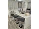 A kitchen island has quartz countertops and bar stool seating at 1930 Dolphin Drive, Kissimmee, FL 34759