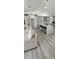 Open-concept living area with gray kitchen, kitchen island, and hardwood floors at 1930 Dolphin Drive, Kissimmee, FL 34759