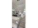 Open-concept living room featuring a gray accent wall, tile floors, and gray cabinets at 1930 Dolphin Drive, Kissimmee, FL 34759