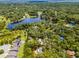 Aerial view of neighborhood, showcasing home nestled on the edge of a small lake at 220 Morton Ln, Winter Springs, FL 32708