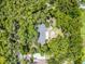 Aerial view of a house nestled among many large mature trees that provide privacy and shade at 220 Morton Ln, Winter Springs, FL 32708
