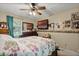 Bedroom features a floral comforter, ceiling fan, and personal touches at 220 Morton Ln, Winter Springs, FL 32708