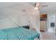 Bright bedroom featuring a four-poster bed, ceiling fan, and wood-look tile flooring at 220 Morton Ln, Winter Springs, FL 32708