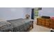 Bedroom showcases a queen bed, window, and dresser at 220 Morton Ln, Winter Springs, FL 32708