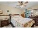 Cozy bedroom with a floral-patterned quilt, dark wood furniture, and ample natural light at 220 Morton Ln, Winter Springs, FL 32708