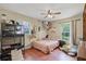 Bedroom with vinyl floors, a bed, and a large window offering outdoor views at 220 Morton Ln, Winter Springs, FL 32708