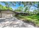 Side view of house showing detached garage and mature landscaping at 220 Morton Ln, Winter Springs, FL 32708