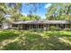 Charming brick ranch home with a well-manicured lawn and mature landscaping at 220 Morton Ln, Winter Springs, FL 32708