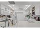 Clean kitchen with white cabinets, tile countertops, and modern appliances at 220 Morton Ln, Winter Springs, FL 32708