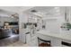 White kitchen open to the living area with tile floor and a breakfast bar at 220 Morton Ln, Winter Springs, FL 32708