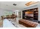Open-concept space with living room and dining room featuring tile floors and built in bookshelf at 220 Morton Ln, Winter Springs, FL 32708