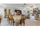 Open-concept living room and dining area with wood-look tile flooring and brick fireplace at 220 Morton Ln, Winter Springs, FL 32708