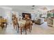 Open-concept living room and dining area with tile floors, entertainment center, and comfortable seating at 220 Morton Ln, Winter Springs, FL 32708